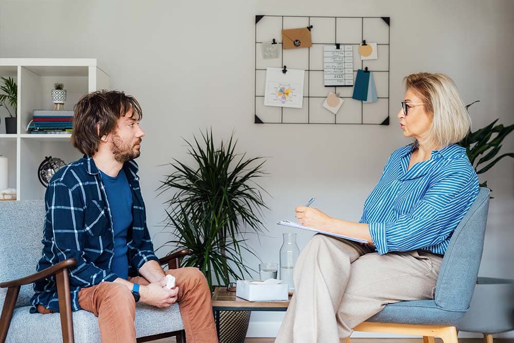 a man seeing a counselor for addiction recovery