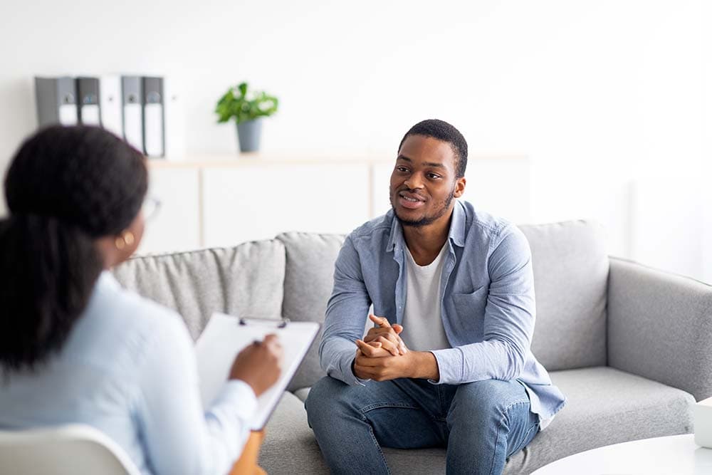 a counsellor listening to a client in a one-to-one session