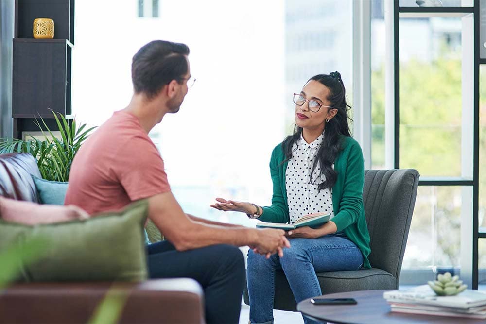 a clinician explaining treatment options to a client