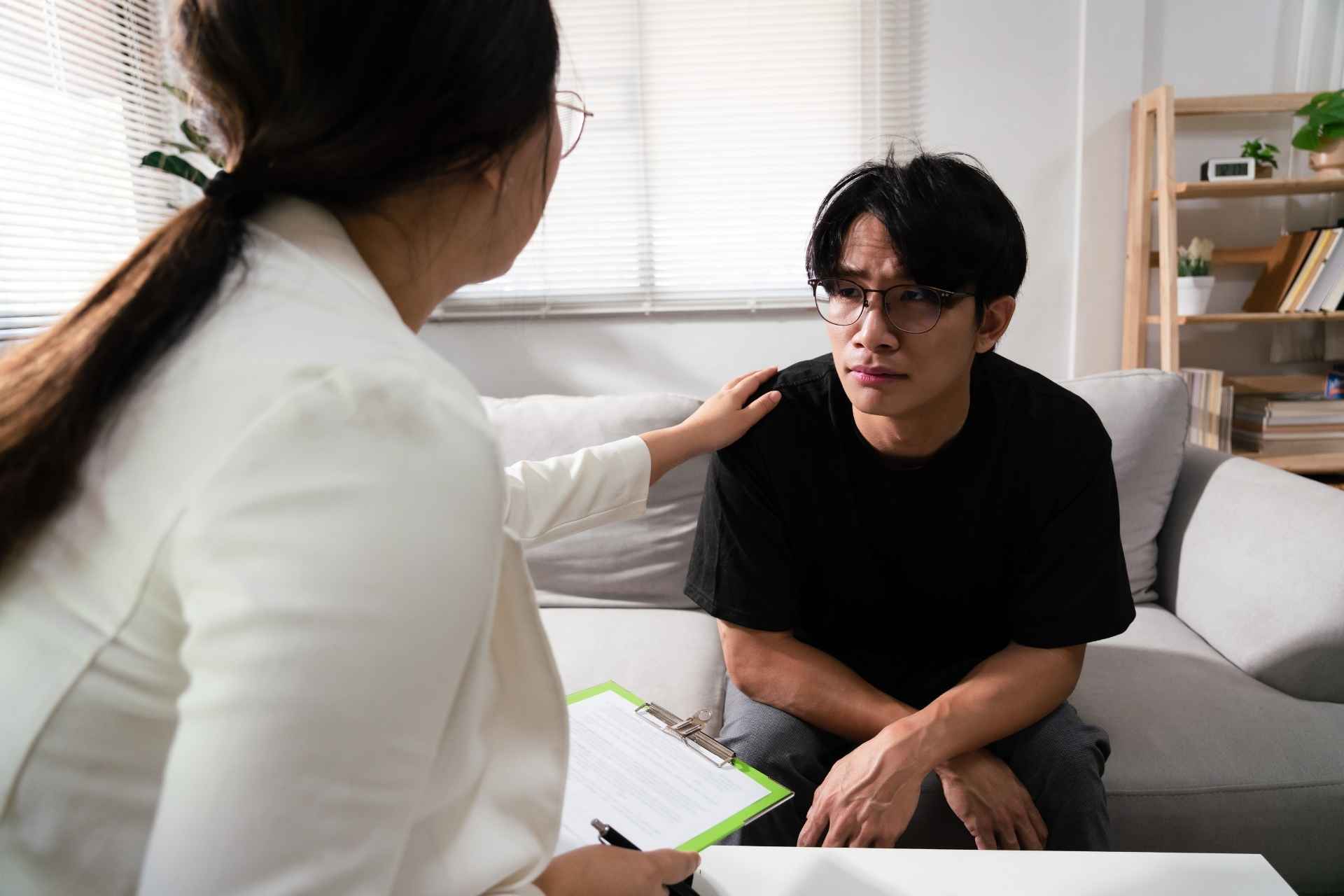 A counselor provides one-on-one counseling to a young adult receiving cocaine addiction treatment