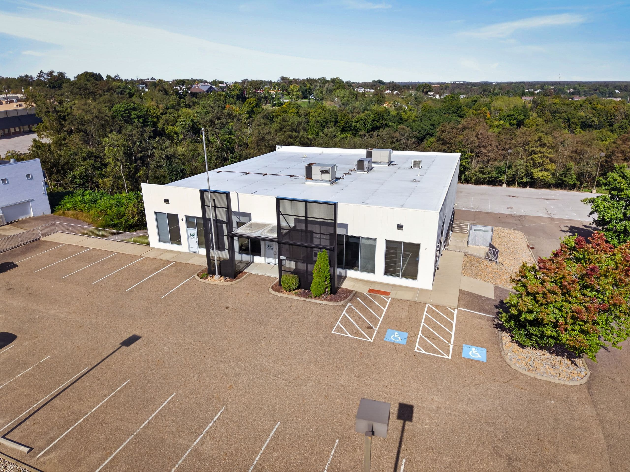 An aerial view of the clinic, its parking lot and the surrounding trees