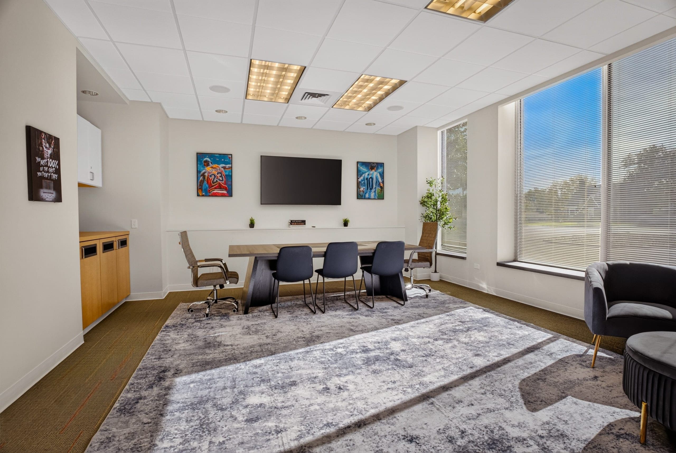 A bright meeting room with a long table and large windows
