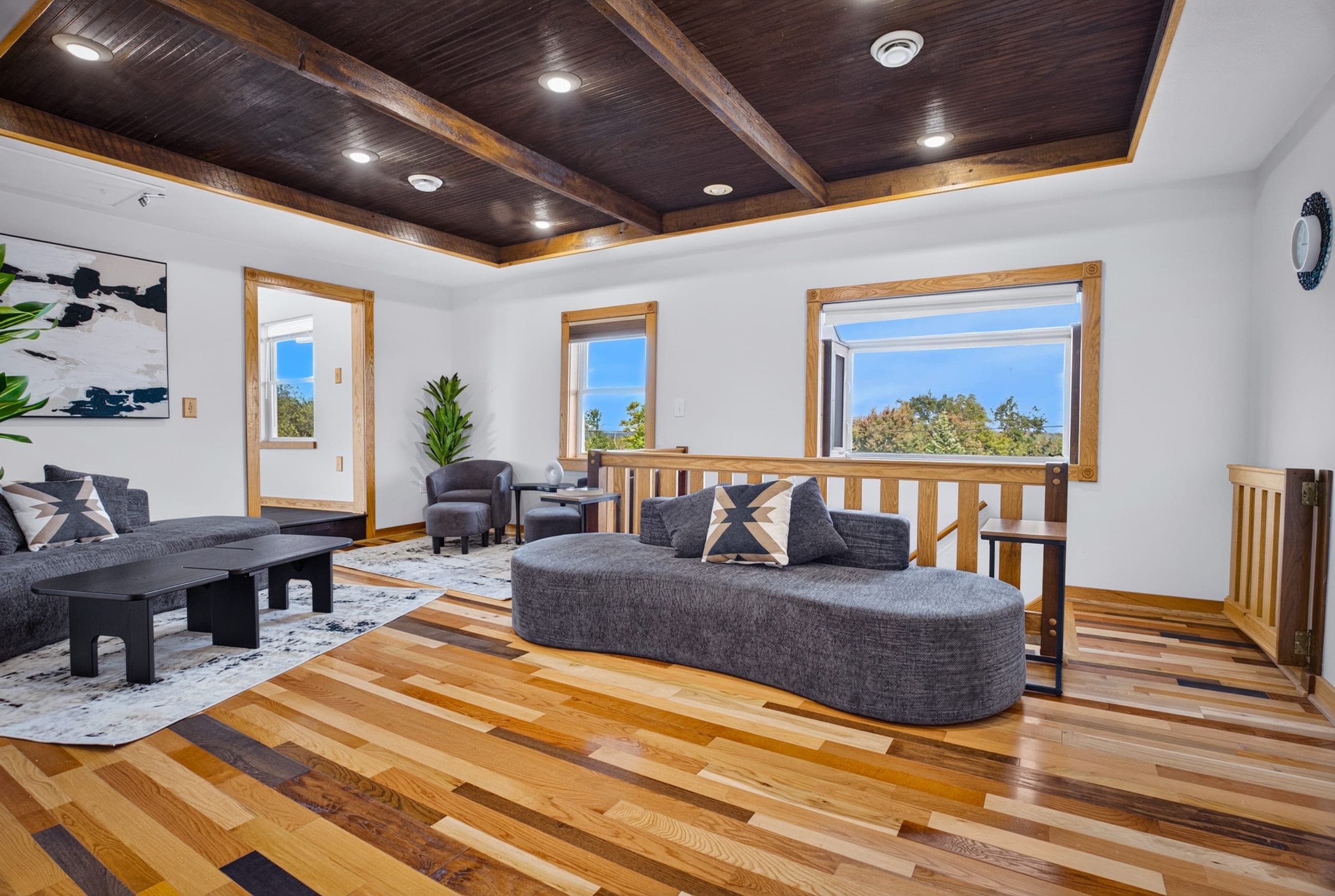 A bright lounge with hardwood floors and seating